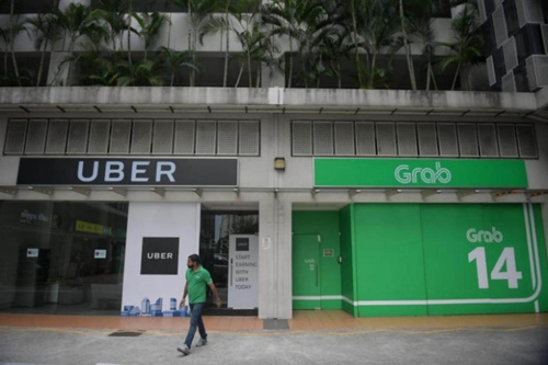 Có cơ sở nghi ngờ vụ Grab mua Uber vi phạm