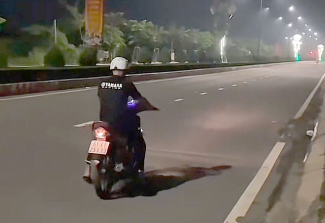 CSGT TP.HCM xử phạt vợ quay clip chồng chạy xe máy bằng 1 bánh rồi đăng lên TikTok - Ảnh 1.