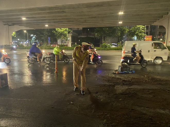 Video CSGT Hà Nội kịp thời dọn vết dầu loang dài 100m trên đường Phạm Văn Đồng - Ảnh 3.